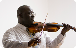 An adult violin student performing