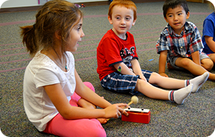 Three young students enjoy an Early Childhood class